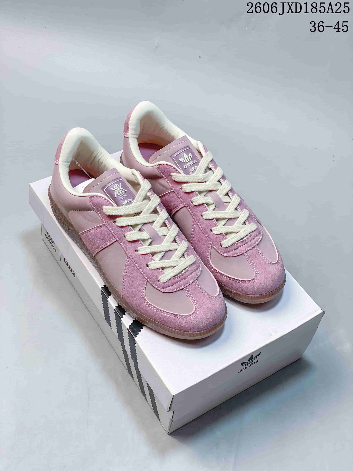 Pink adidas BW Army low-top sneakers with cream laces, shown on a shoebox.