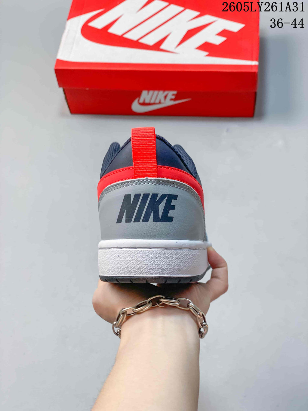 Rear view showing the gray heel panel, red heel accent, and white midsole