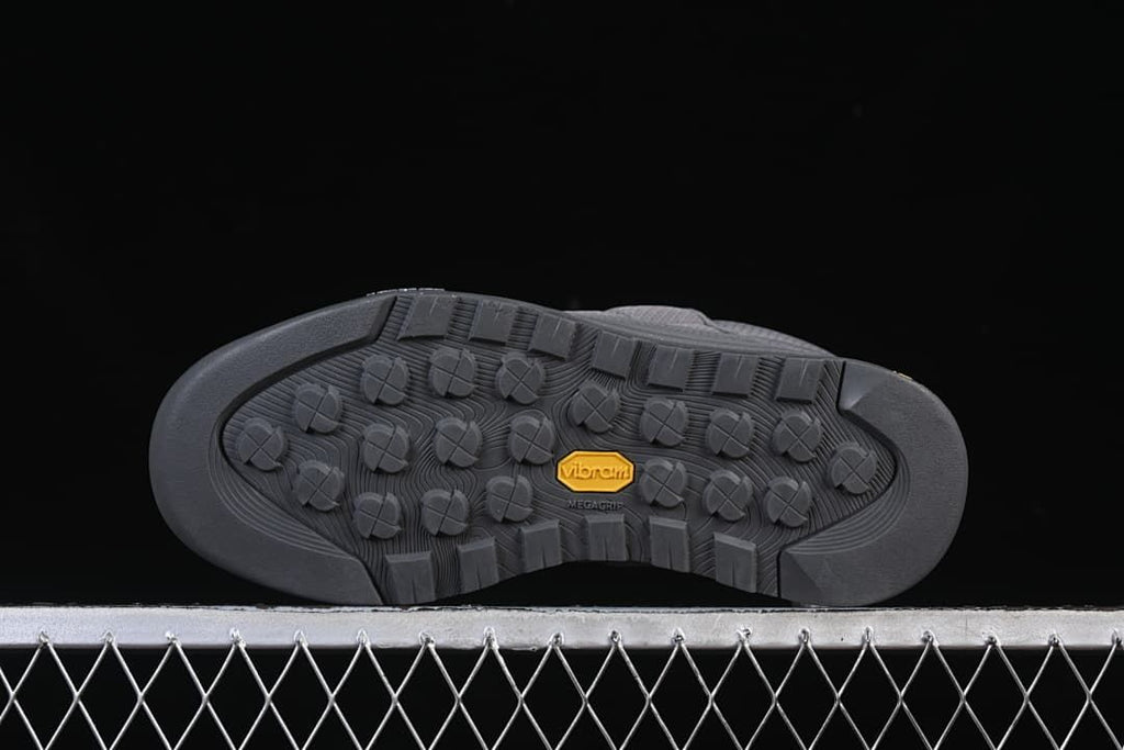 Outsole with lugged tread and Vibram marking