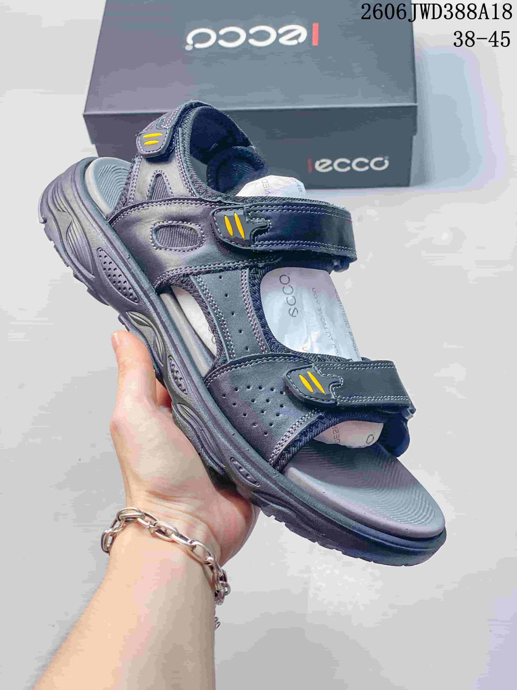 Angled view of a dark navy and gray ECCO sandal with yellow strap accents
