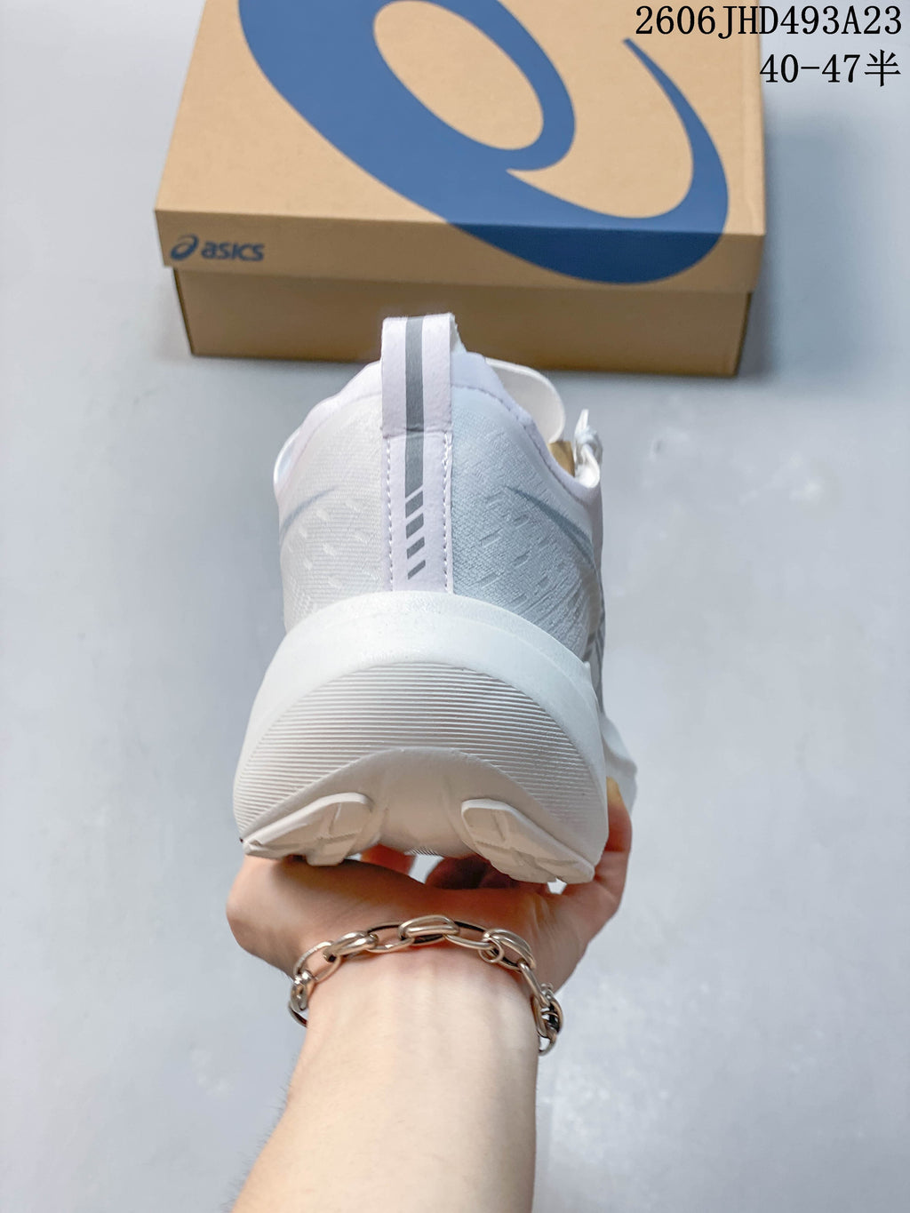 Rear view of a white running shoe with a heel pull tab