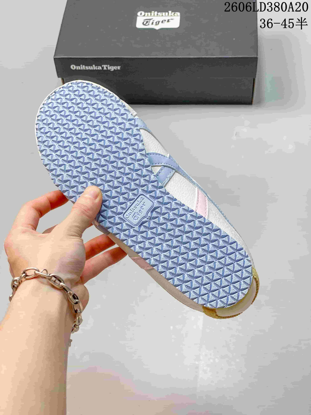 Close view of the textured light blue outsole on an Onitsuka Tiger sneaker.