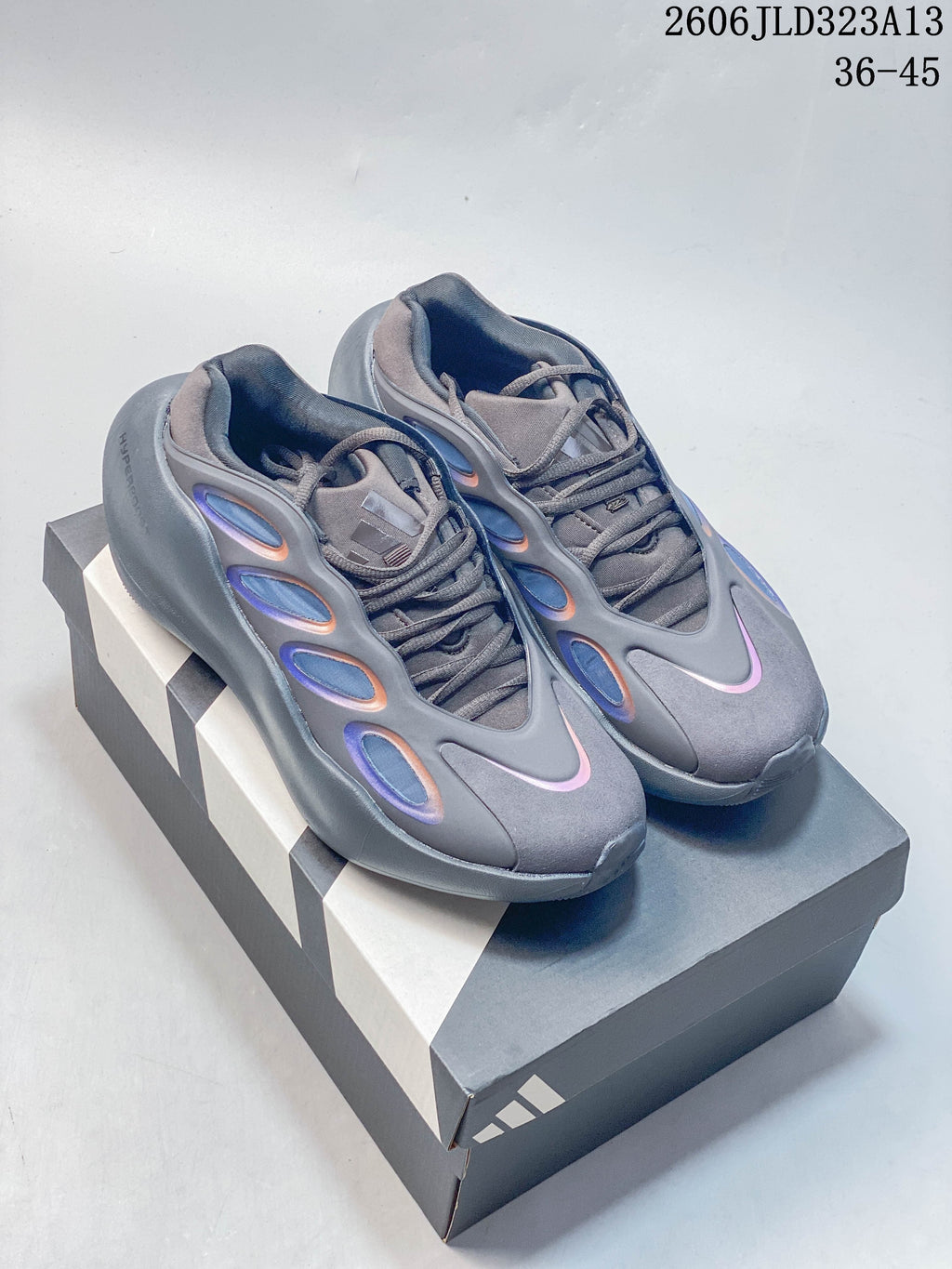 Pair of gray The North Face Hedgehog sneakers on a shoebox, showing the lace-up design and iridescent side accents.