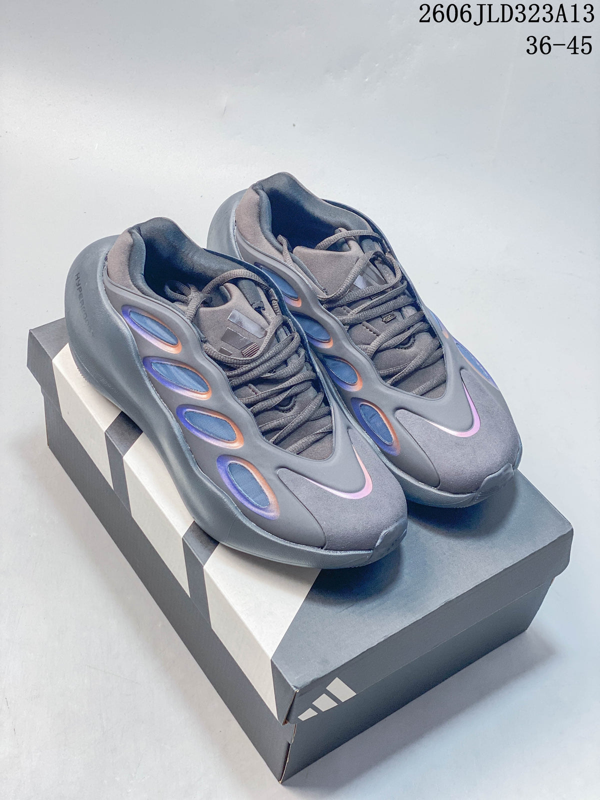 Pair of gray The North Face Hedgehog sneakers on a shoebox, showing the lace-up design and iridescent side accents.