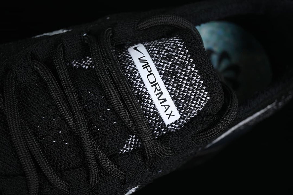 Close-up of the Vapormax tongue label and black laces