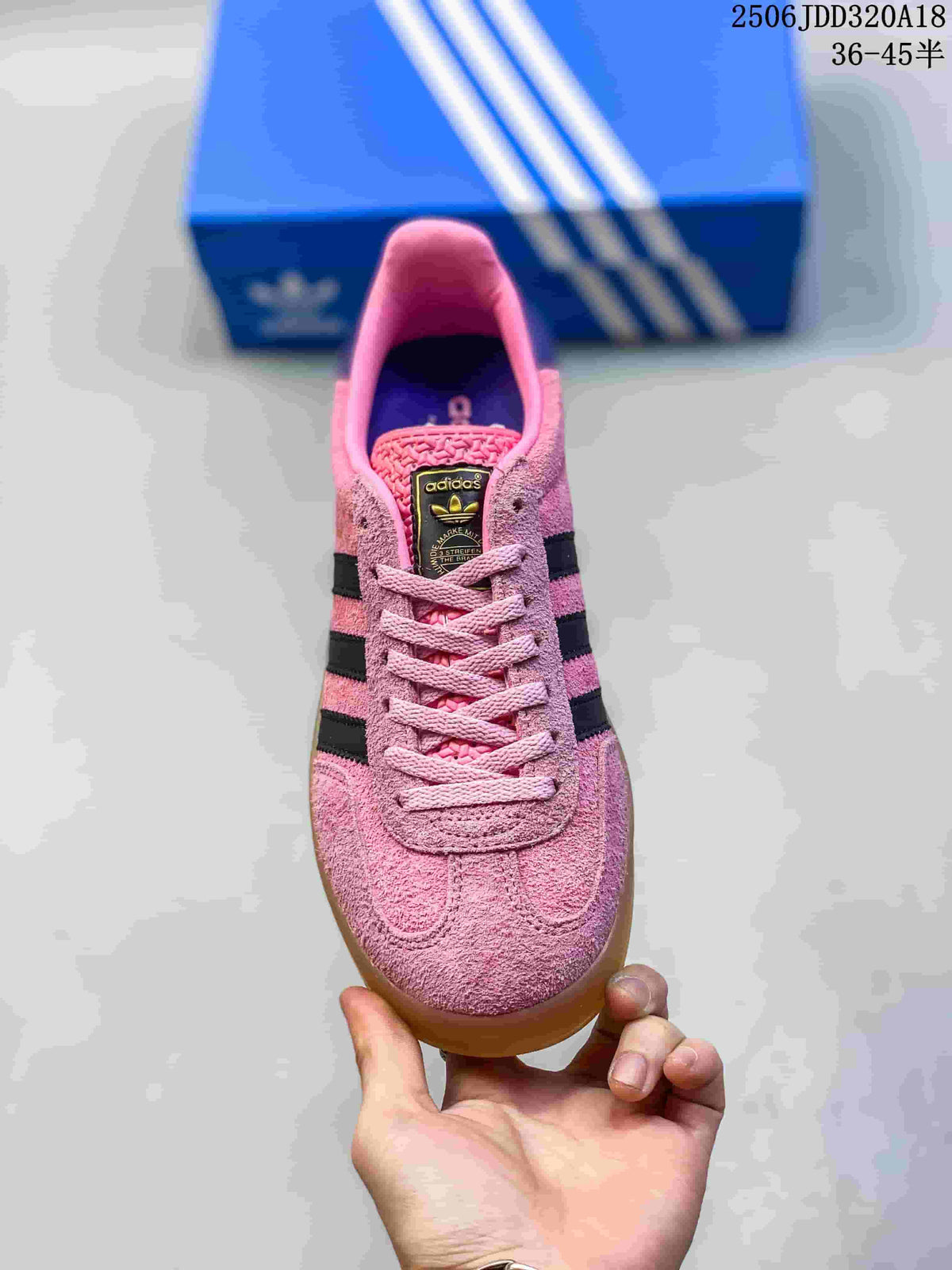 Top view of the pink lace-up sneaker with dark stripes and a contrasting tongue label.