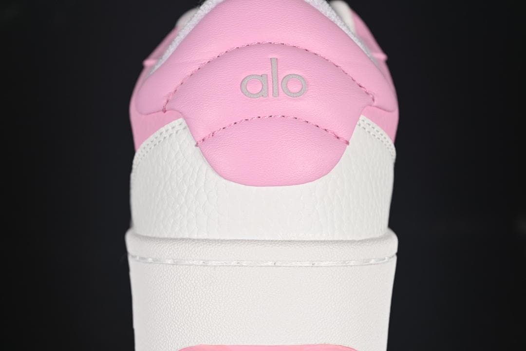 Rear view showing pink heel panels, white overlays, and Alo branding