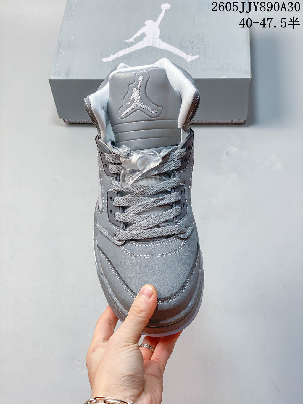 Front view of a grey Jordan Air Jordan 5 Retro sneaker with lace lock