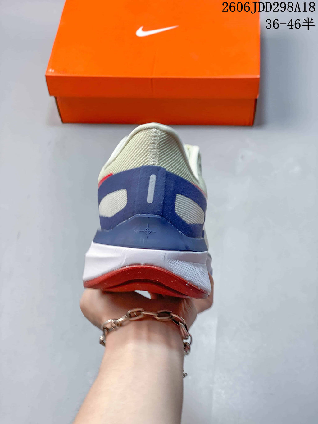Rear view of the shoe with blue heel detailing and a red outsole