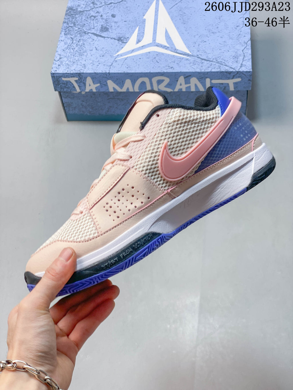 Side view of the Nike Ja 1 EP with mesh panels, pink Swoosh, and blue heel accents.