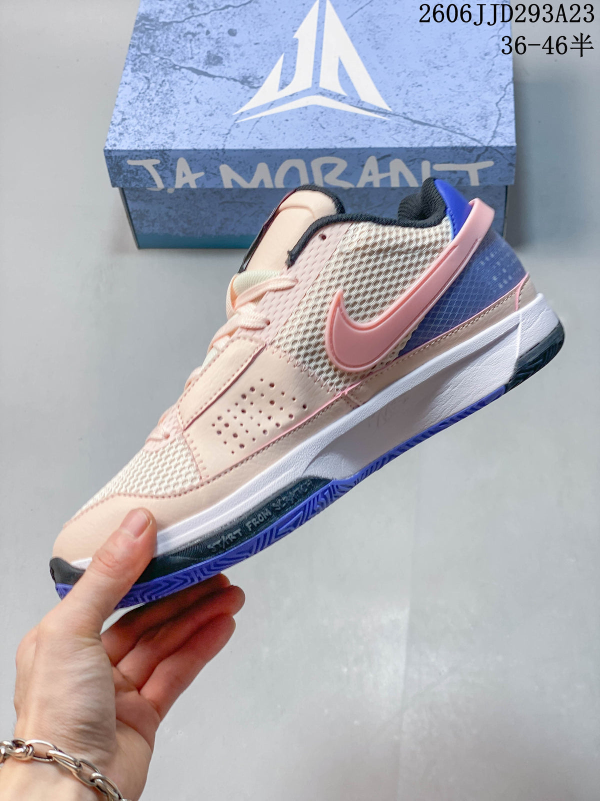 Side view of the Nike Ja 1 EP with mesh panels, pink Swoosh, and blue heel accents.