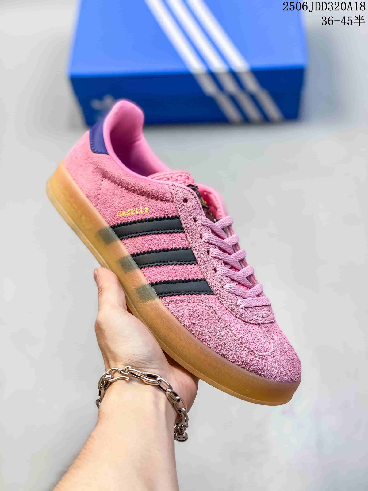 Side view of the pink Adidas Gazelle sneaker with three dark stripes and a gum-colored sole.