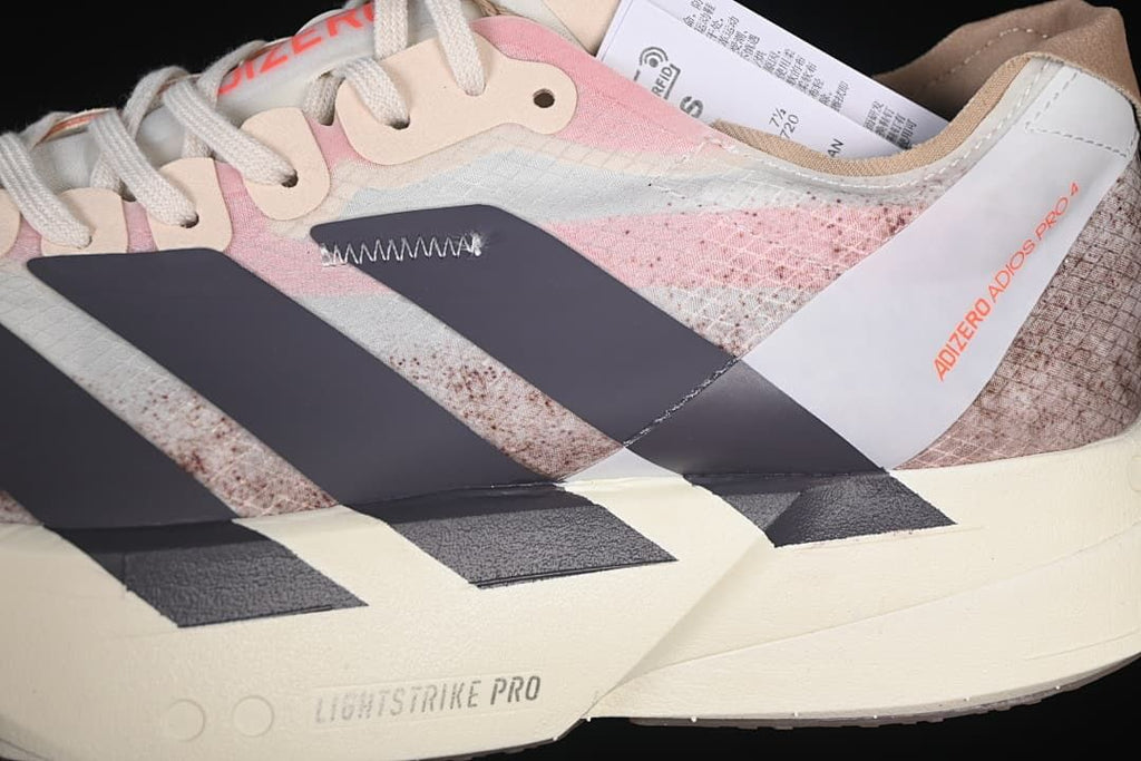 Close-up of the shoe's patterned upper, dark stripes, laces and Lightstrike Pro marking