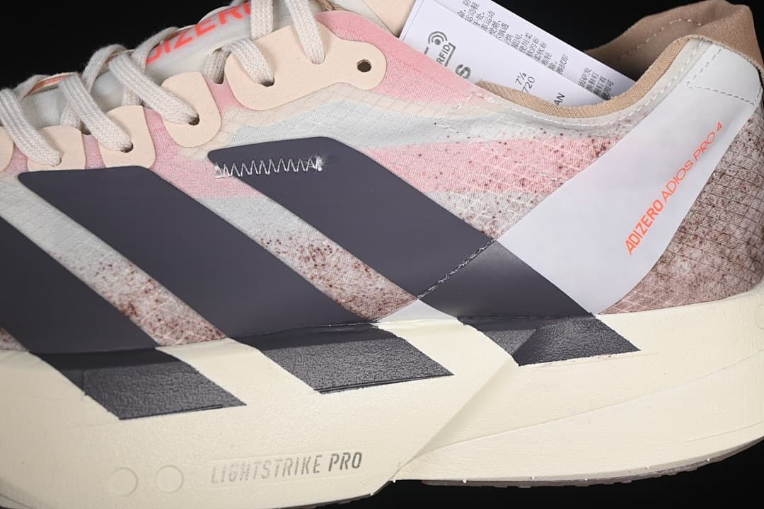 Close-up of the shoe's patterned upper, dark stripes, laces and Lightstrike Pro marking