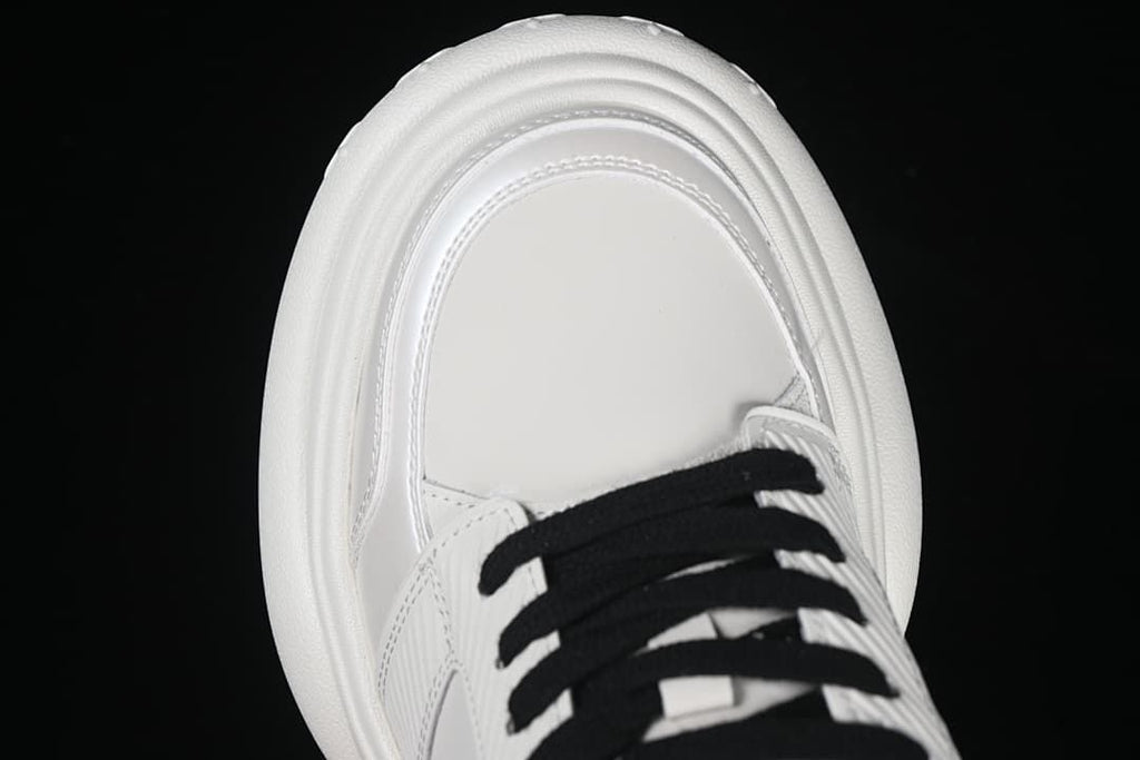 Top view of the white toe box and black laces