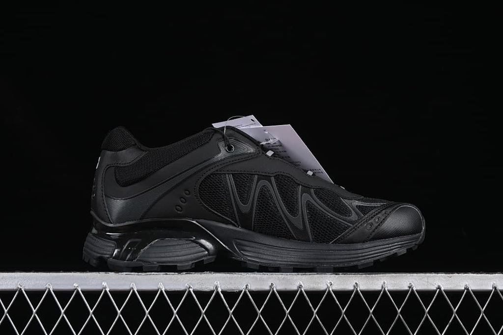 Side profile showing the black shoe's layered design