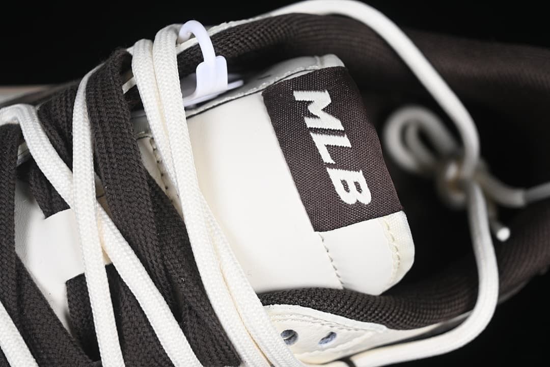 Close-up of tongue label with MLB lettering and layered laces