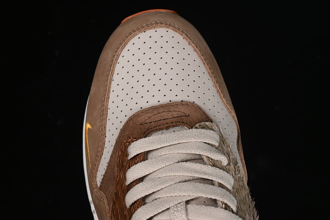 Top-down close-up of the perforated toe box and laces.