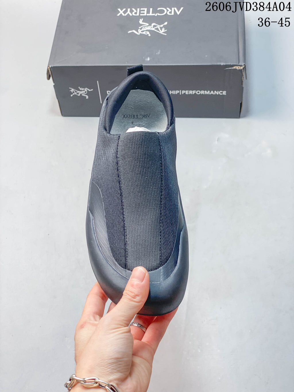 Top view of a dark gray slip-on shoe showing its stretchy upper