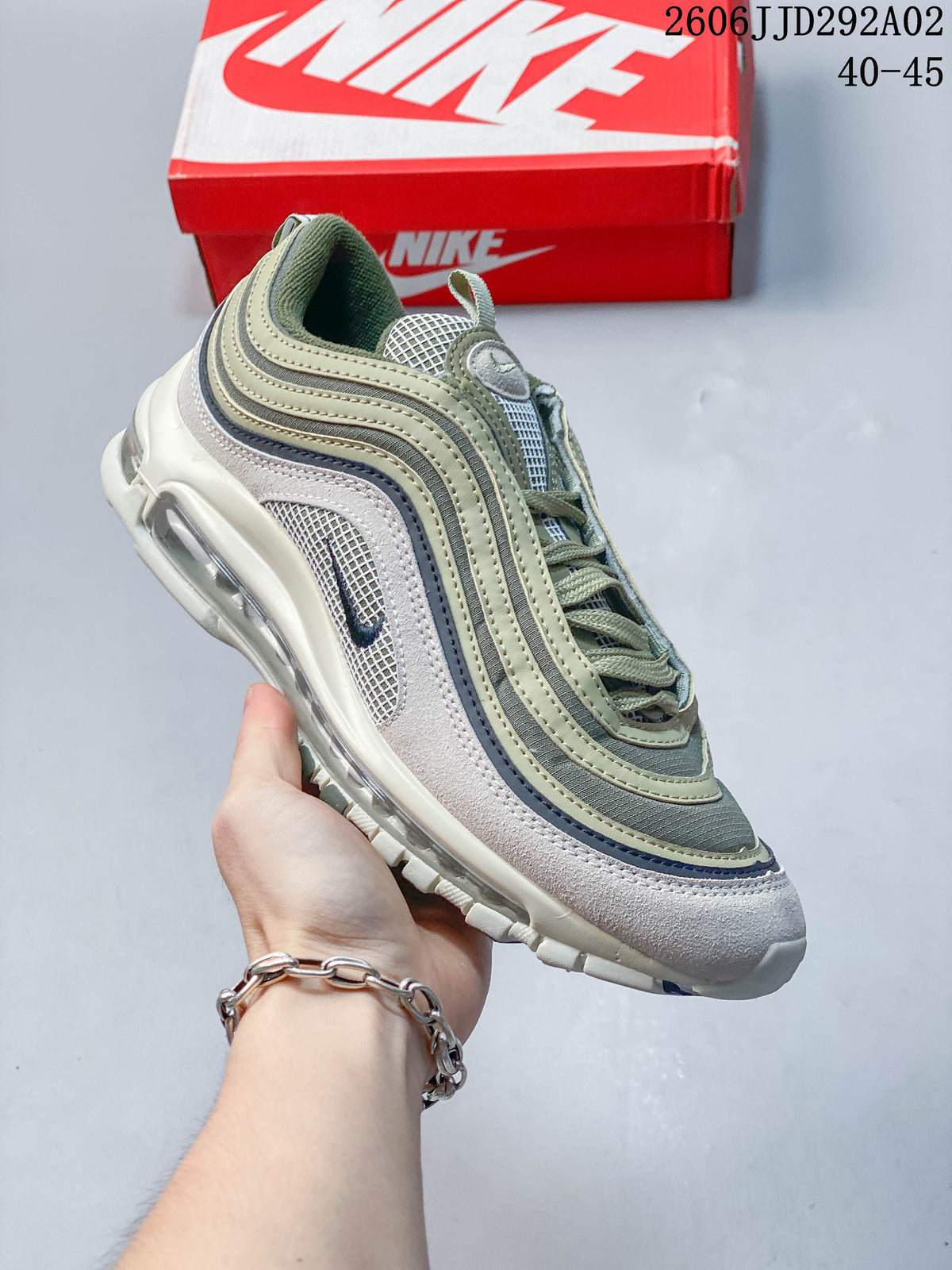 Angled side view of a Nike Air Max 97 sneaker in muted green, gray, and white