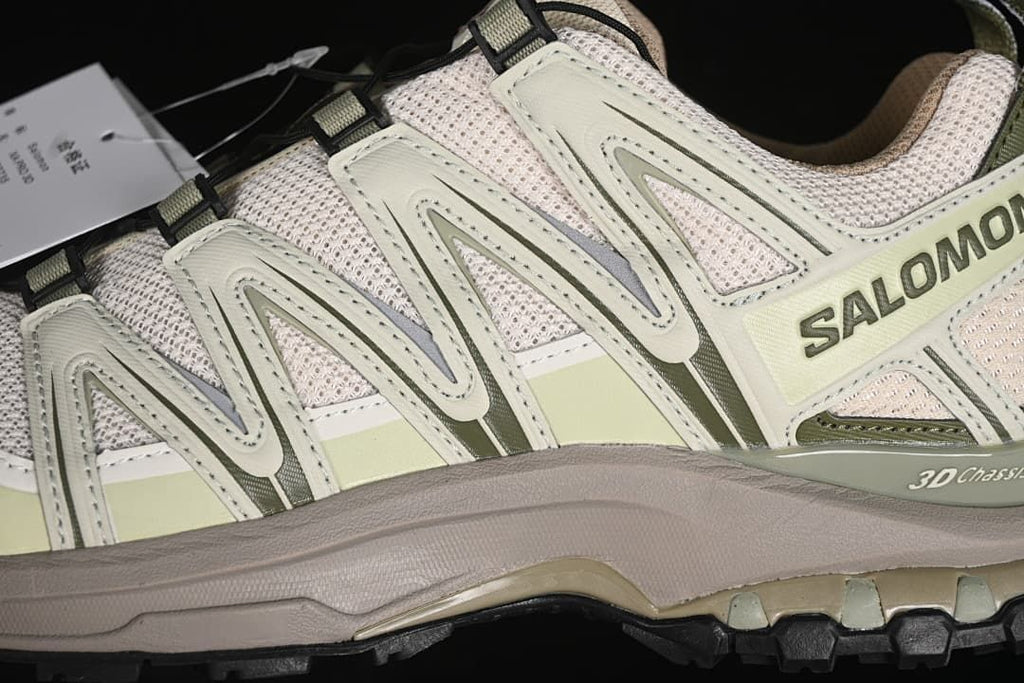 Close-up of the side overlays, mesh upper, and trail-style outsole.