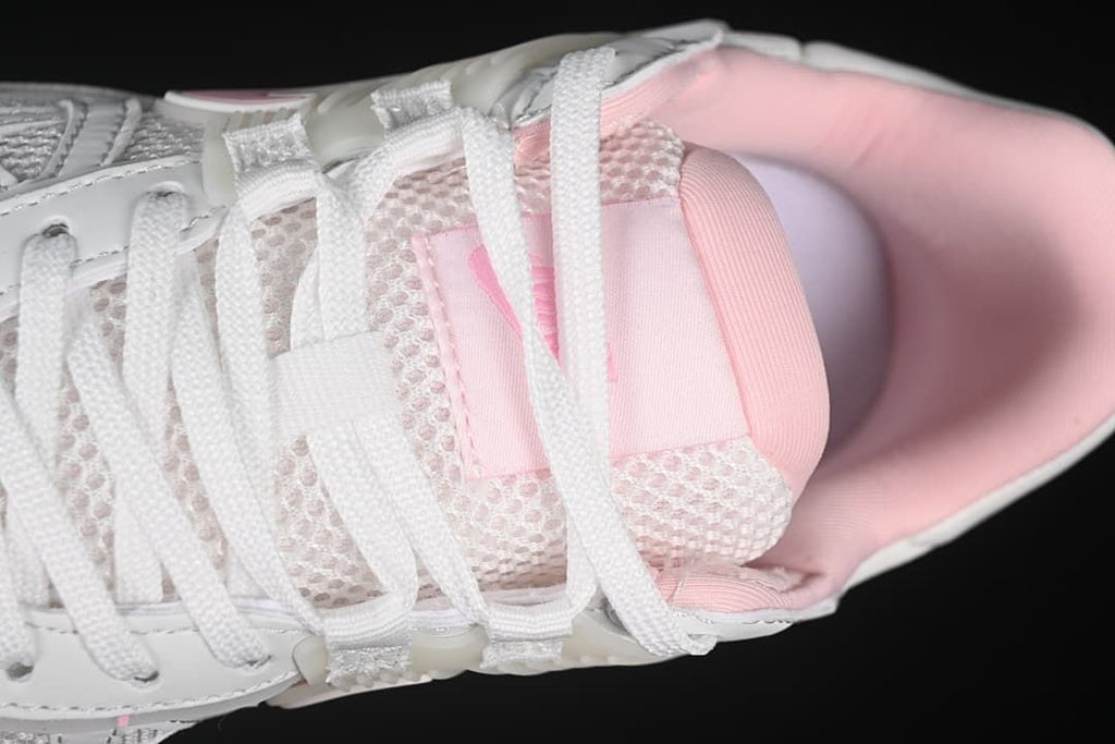 Top close-up of the laces, mesh-look tongue, and pink lining