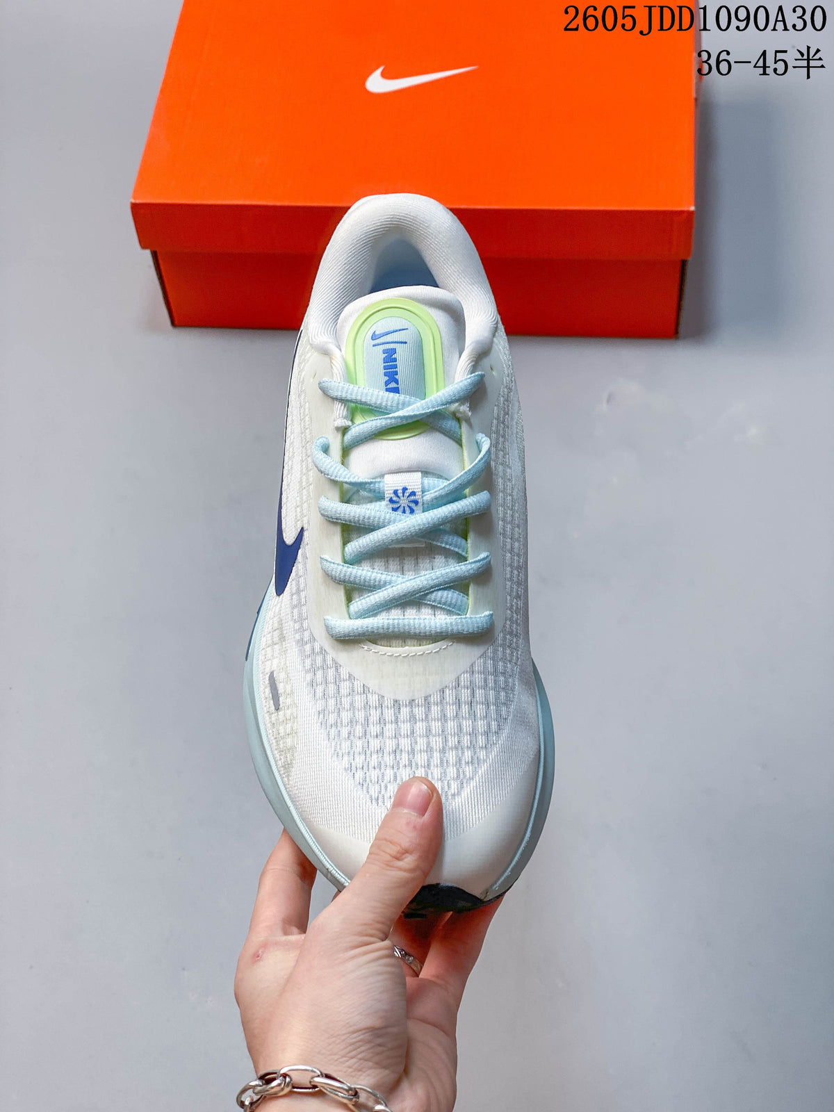 Top view of the Nike Journey Run shoe showing its mesh-patterned toe and light blue laces.