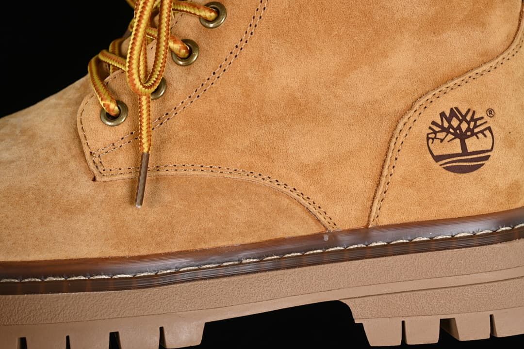 Close-up of the boot upper, stitching, laces and Timberland tree logo