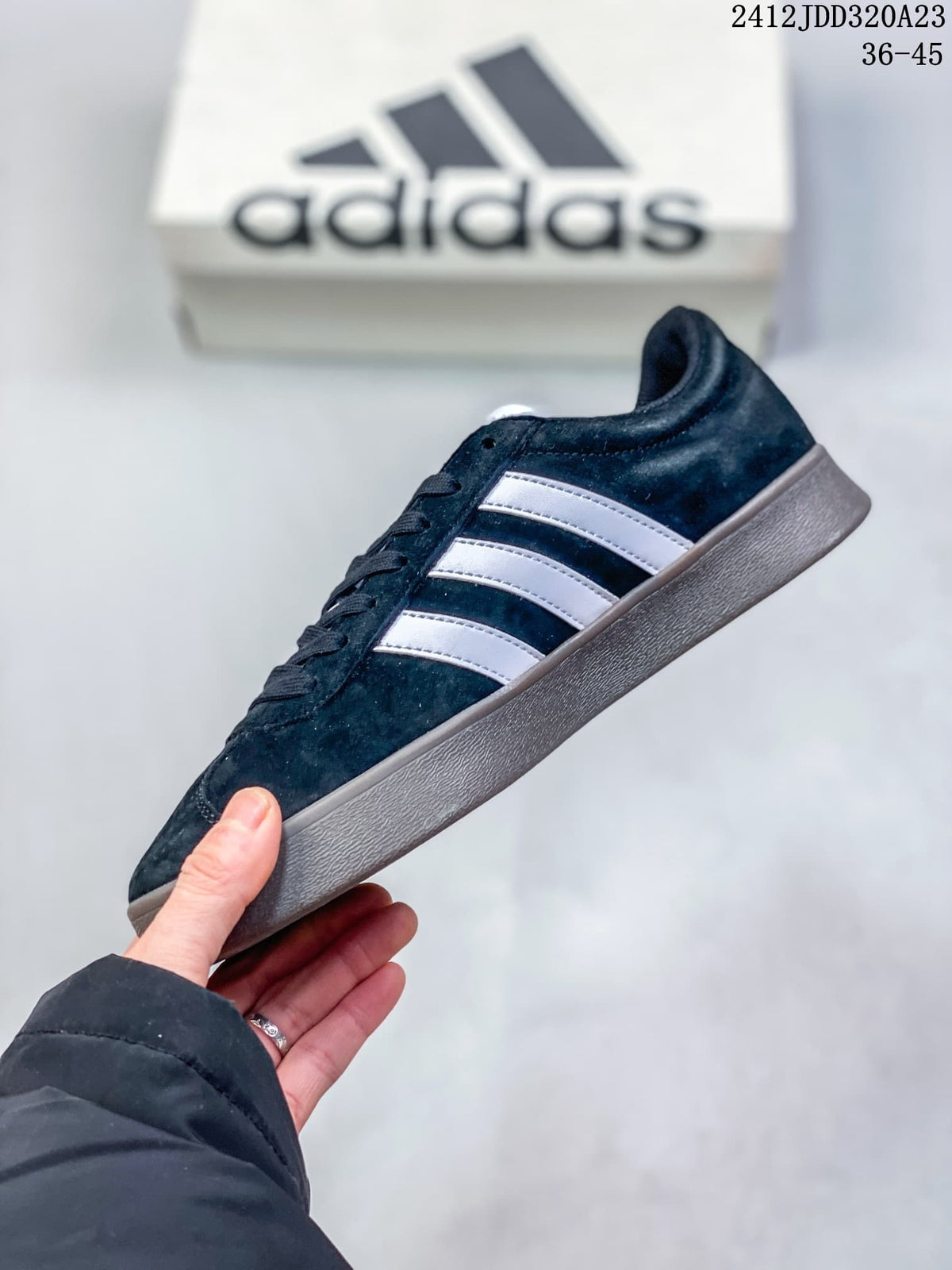 Side profile of a black Adidas VL Court Classic sneaker with white stripes and a gray sole