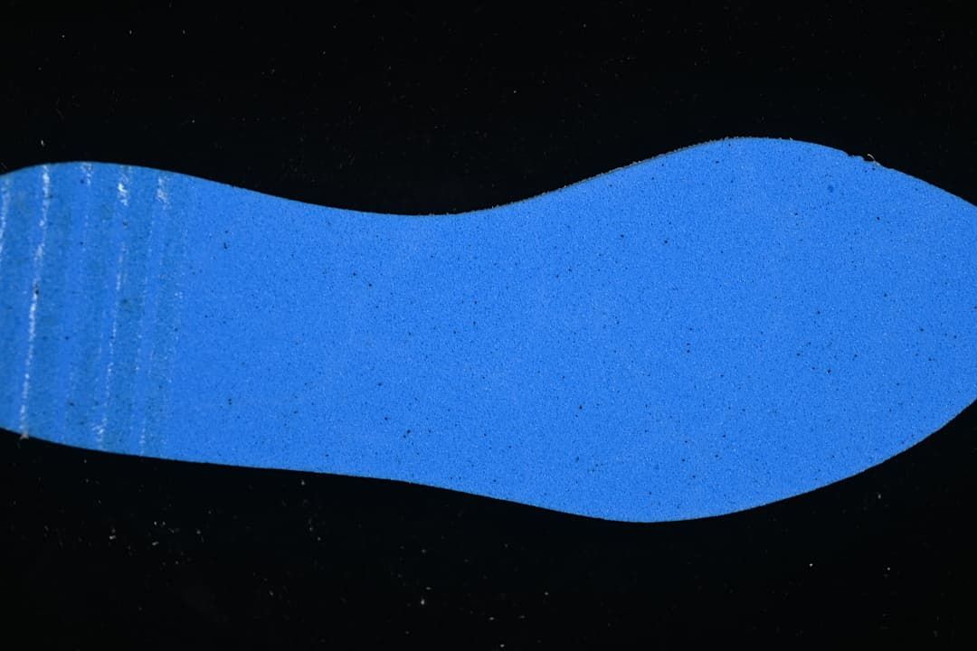Blue shoe-shaped insert displayed against a dark background
