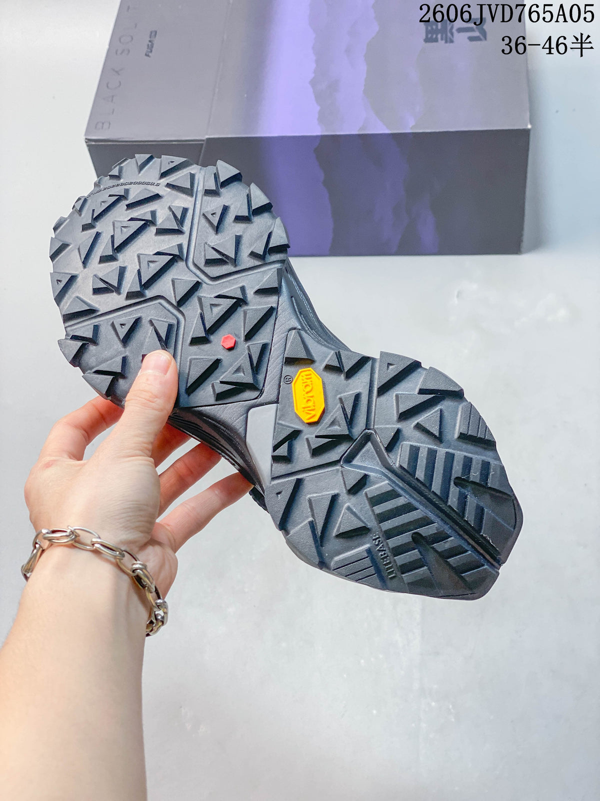 Close-up of the lugged outsole, with a Vibram marking visible