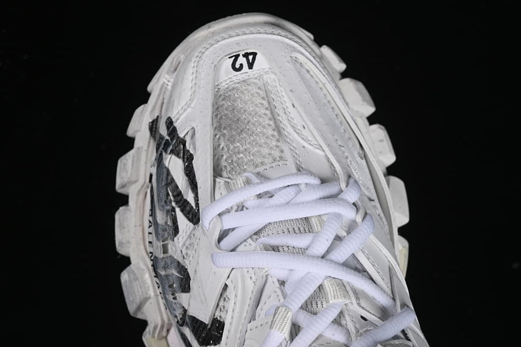 Top view of the white sneaker with EU 42 printed near the toe
