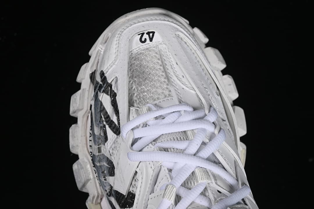 Top view of the white sneaker with EU 42 printed near the toe