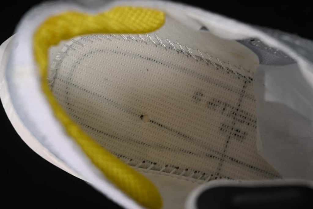 Close-up view inside the shoe showing the footbed and yellow heel lining