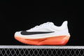 Side view of a white Nike Zoom Fly 6 EK running shoe with black Swoosh and coral-orange sole