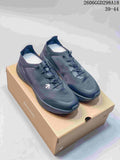 Dark navy DESCENTE low-top running sneakers on a branded shoe box