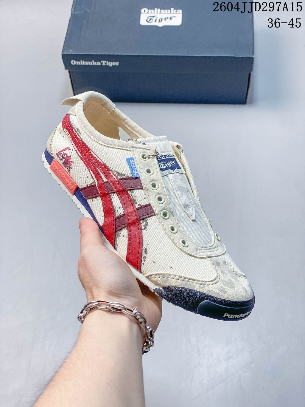 Cream Onitsuka Tiger sneaker with red and burgundy stripes and patterned panels