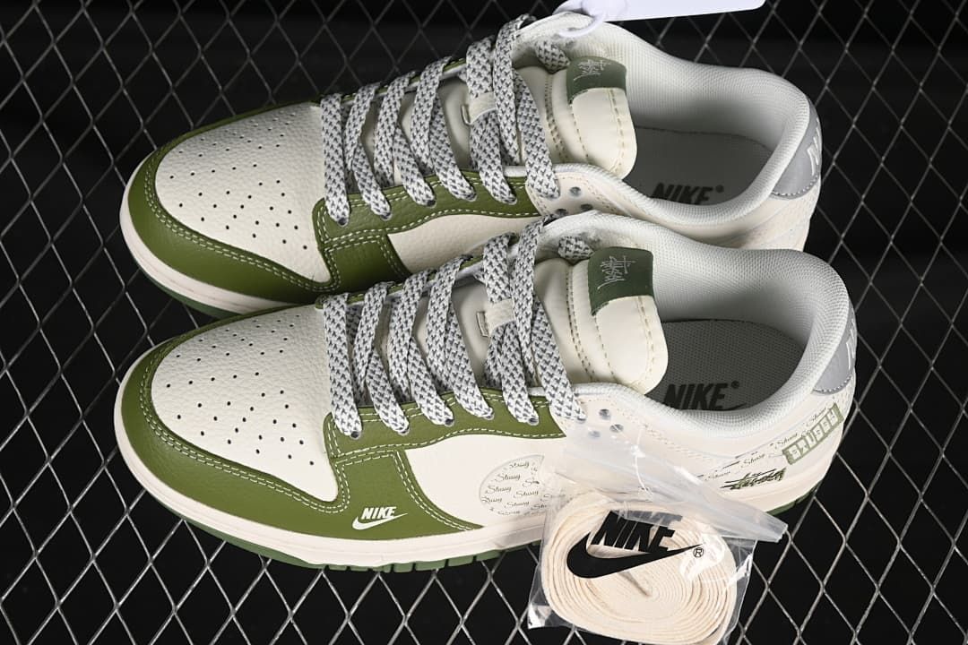 Top view of a pair of olive green and off-white Nike SB Dunk Low sneakers, with an extra pair of light-colored laces shown.
