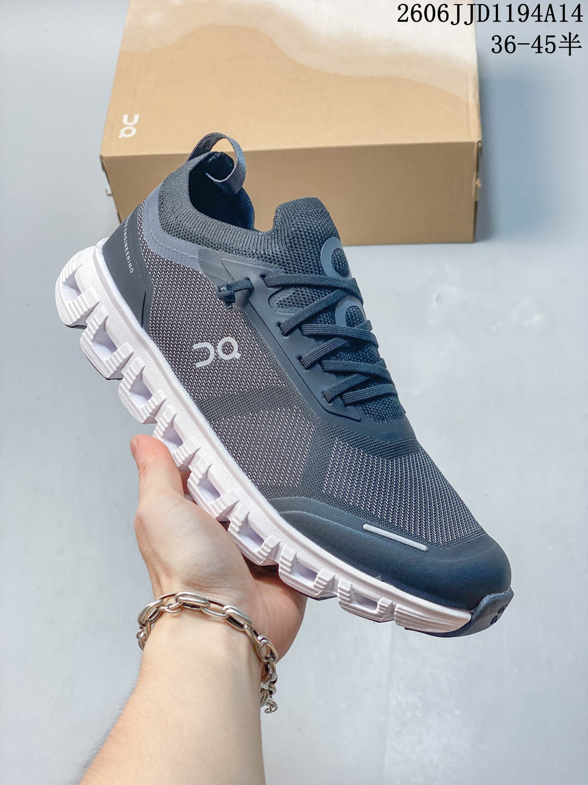 Close-up of a dark gray On Cloud 6 Versa shoe with textured upper and white outsole