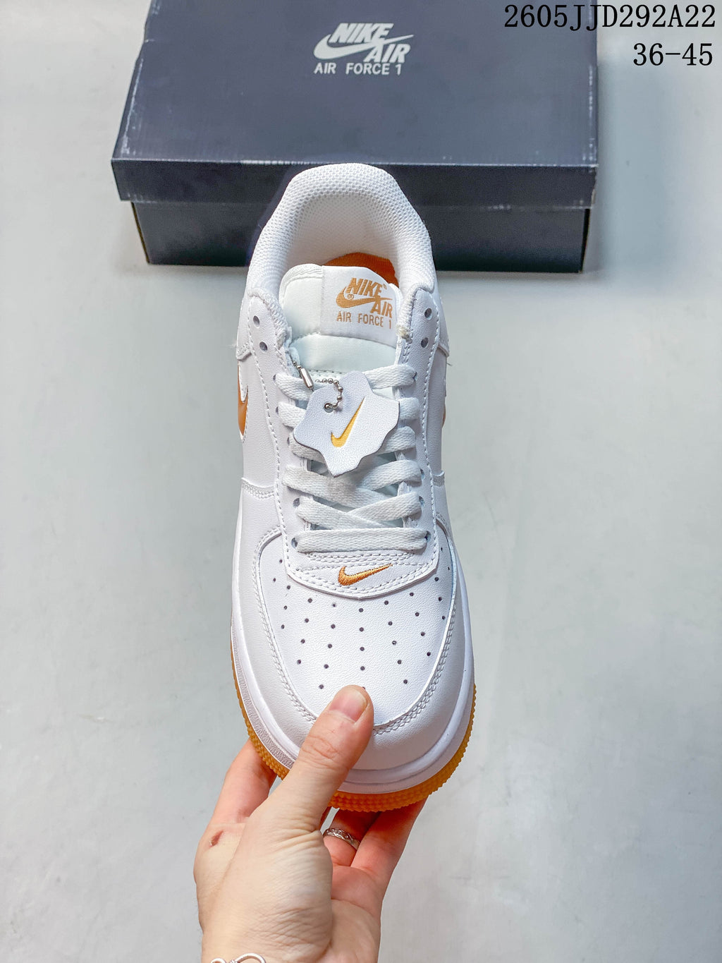 Top view of the sneaker showing its perforated toe, white laces, and orange details