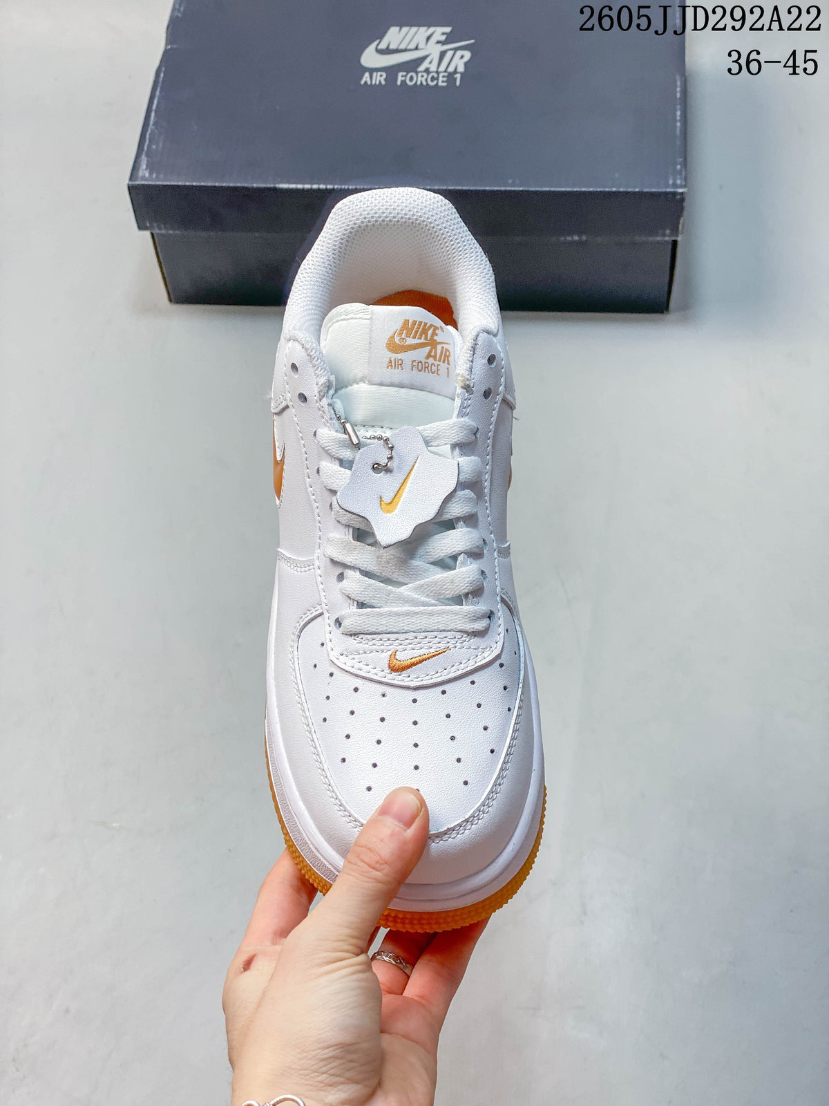Top view of the sneaker showing its perforated toe, white laces, and orange details