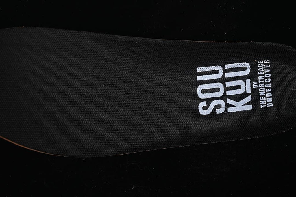 Close-up of black insole marked Soukuu by The North Face Undercover