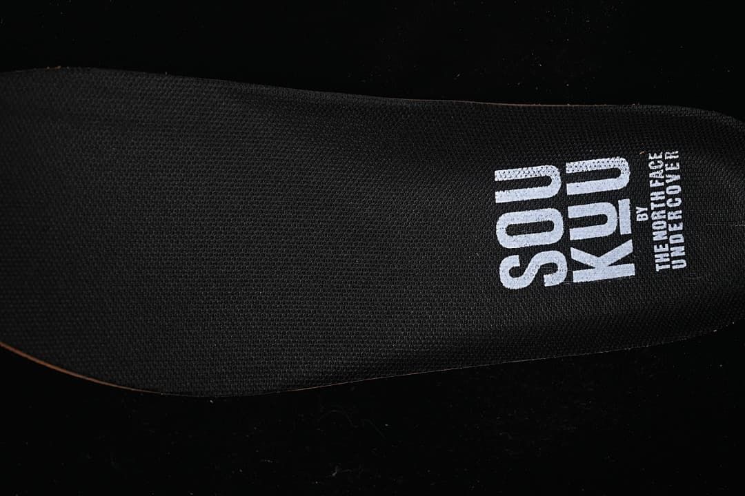 Close-up of black insole marked Soukuu by The North Face Undercover
