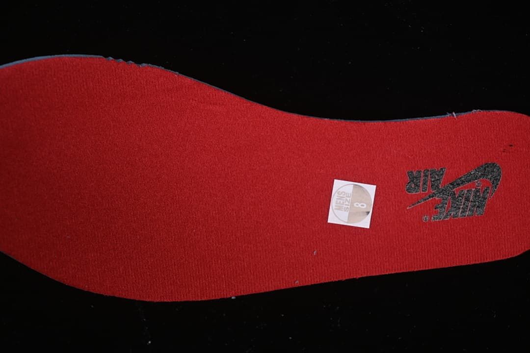 Red shoe insole with a size 8 men’s sticker.