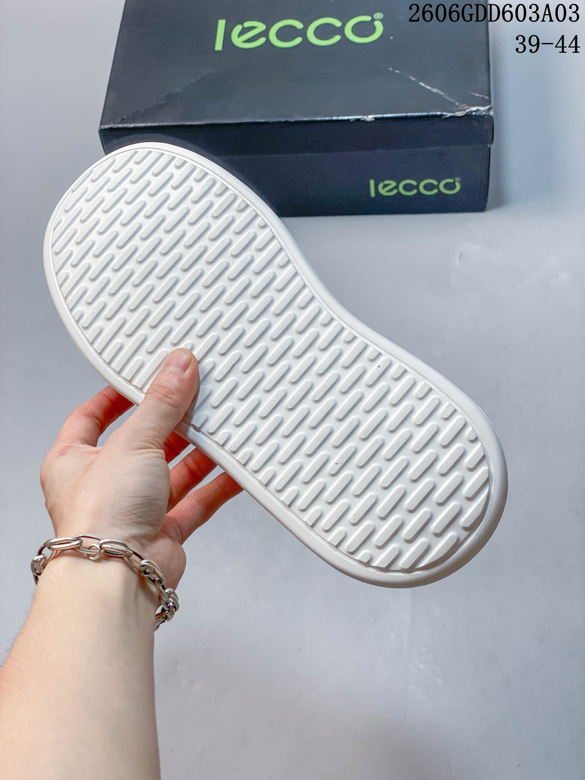 White outsole with a repeating tread pattern