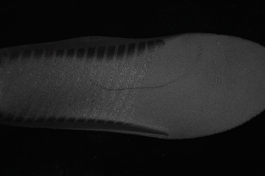 Close-up of the dark textured sneaker outsole