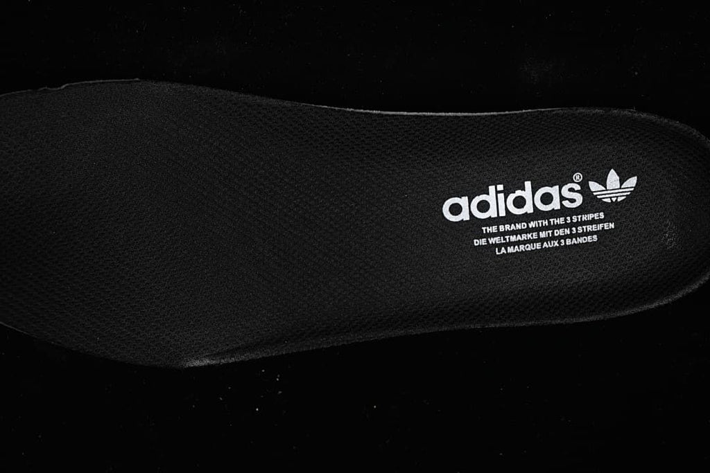 Close-up of the black insole with adidas branding.
