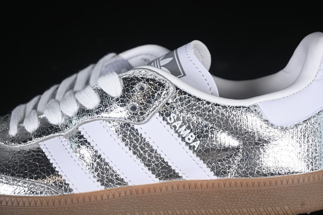Close-up of the silver upper, white stripes and Samba side branding