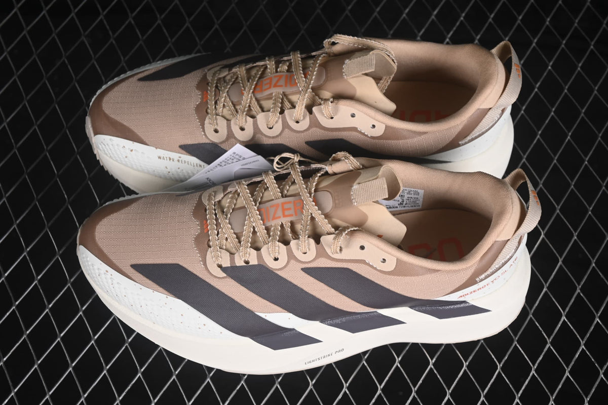 Angled overhead view of the pair showing the beige and cream colorway, lace details and contrasting stripe panels.