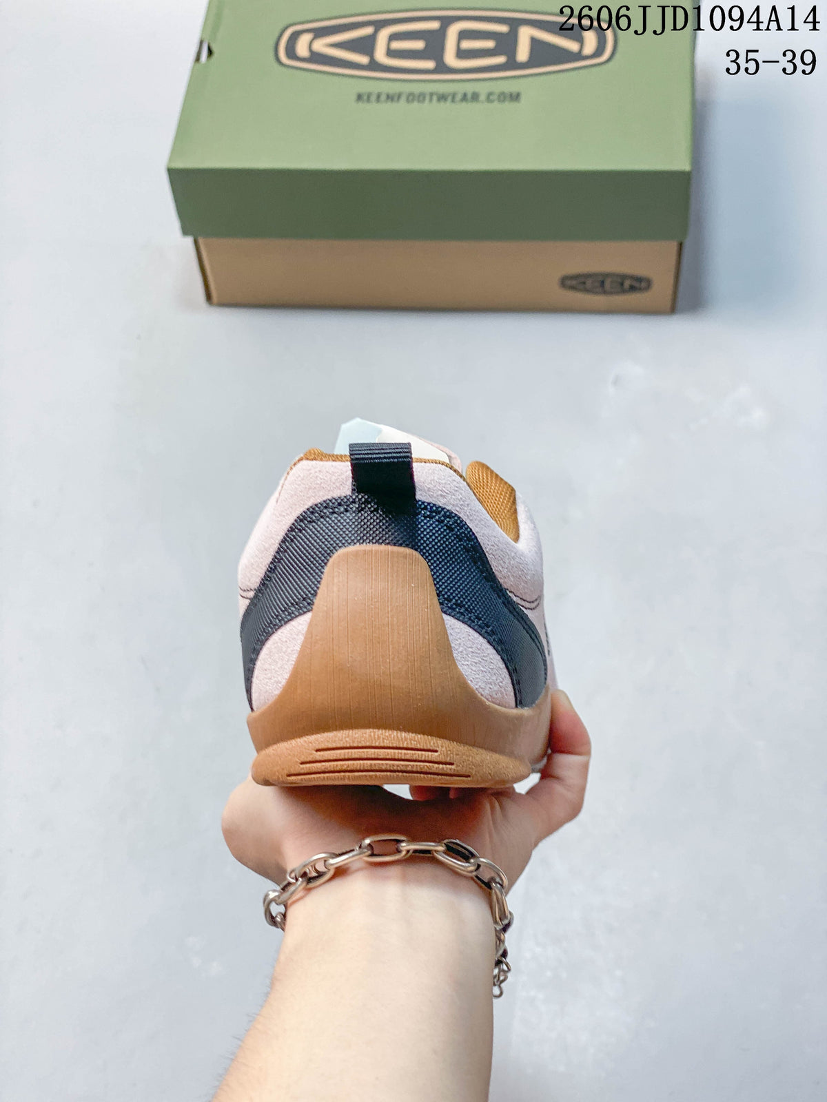 Rear view of a pale pink KEEN Jasper sneaker with navy heel detailing